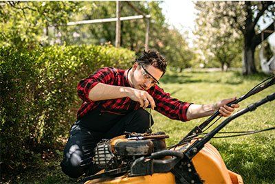 Man Repairs the Lawn Mower — Loganville, GA — Stephens Repair Shop Man Repairs the Lawn Mower — Loganville, GA — Stephens Repair Shop