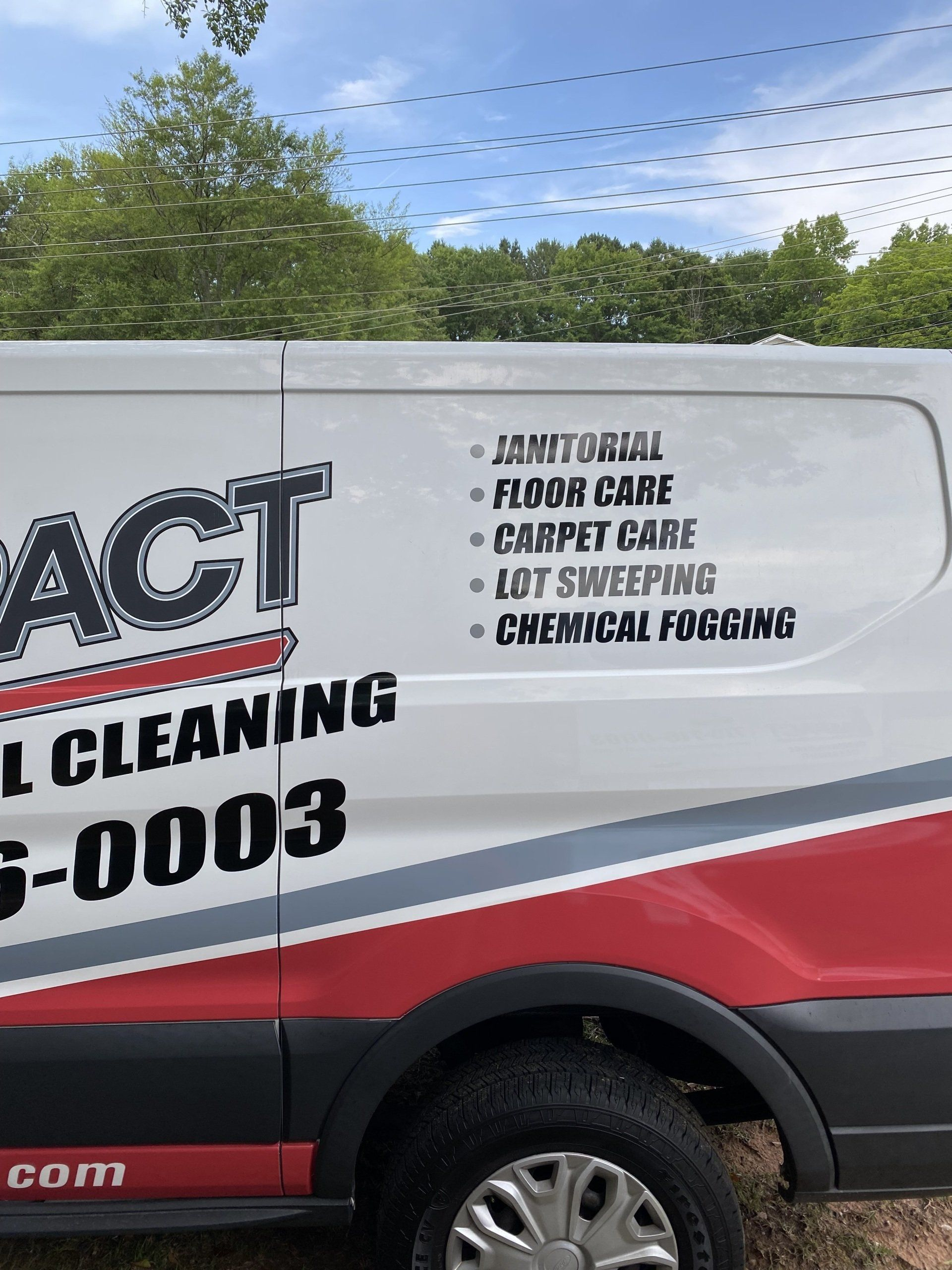 White cleaning van with red and gray accents; lists cleaning services: Janitorial, floor, carpet care.