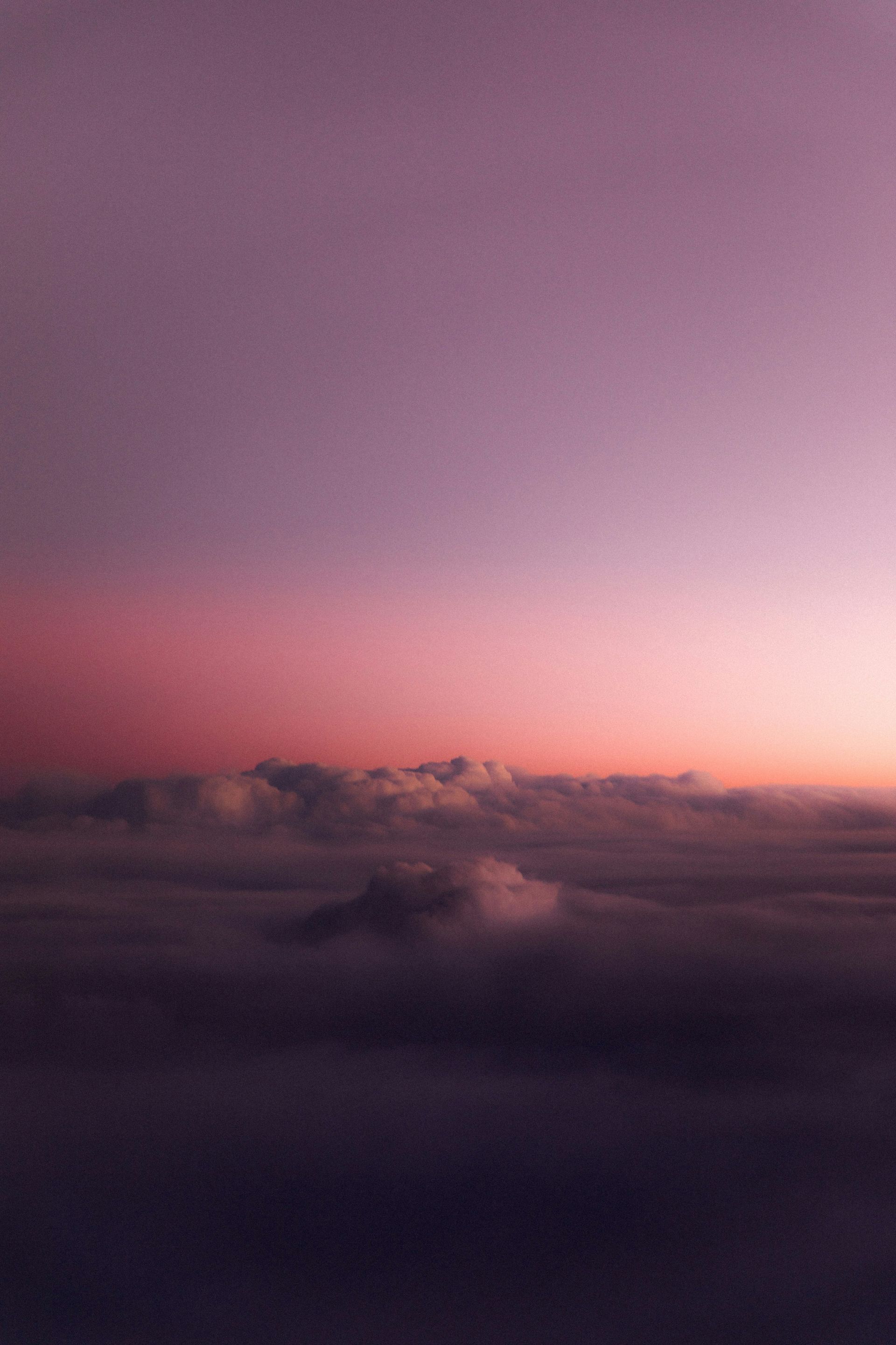 A view of the clouds from an airplane at sunset.