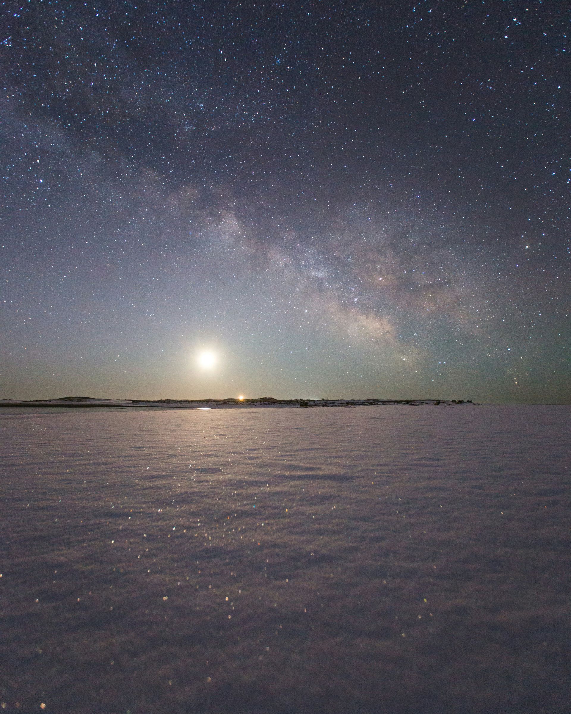 A starry night sky over a body of water