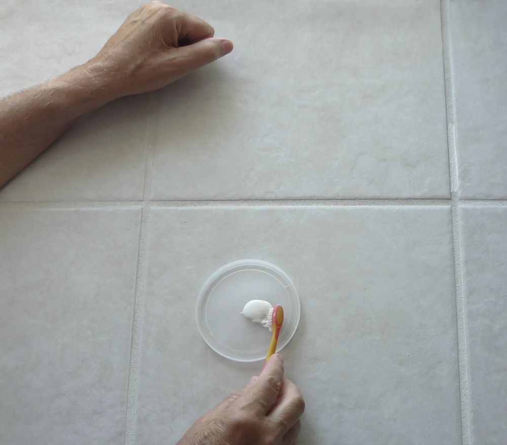 A Person is Brushing Their Teeth on a Tiled Floor — The Tile & Stone Specialists in Buderim, QLD