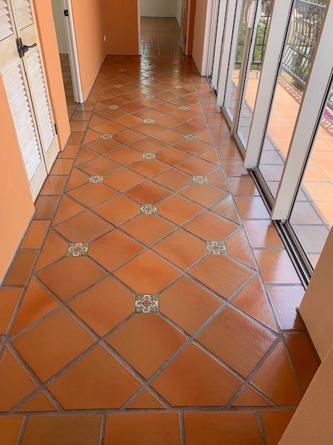 A Hallway With a Tiled Floor and Lots of Windows — The Tile & Stone Specialists in Peregian Beach, QLD
