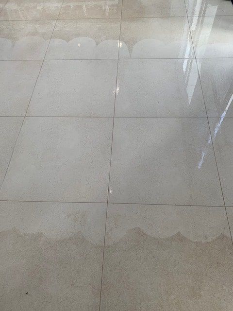 A Close Up of a Tiled Floor With a Reflection of a Window — The Tile & Stone Specialists in Peregian Beach, QLD