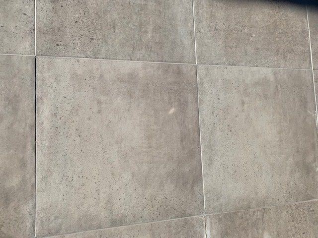A Close Up of a Gray Tile Floor — The Tile & Stone Specialists in Peregian Beach, QLD