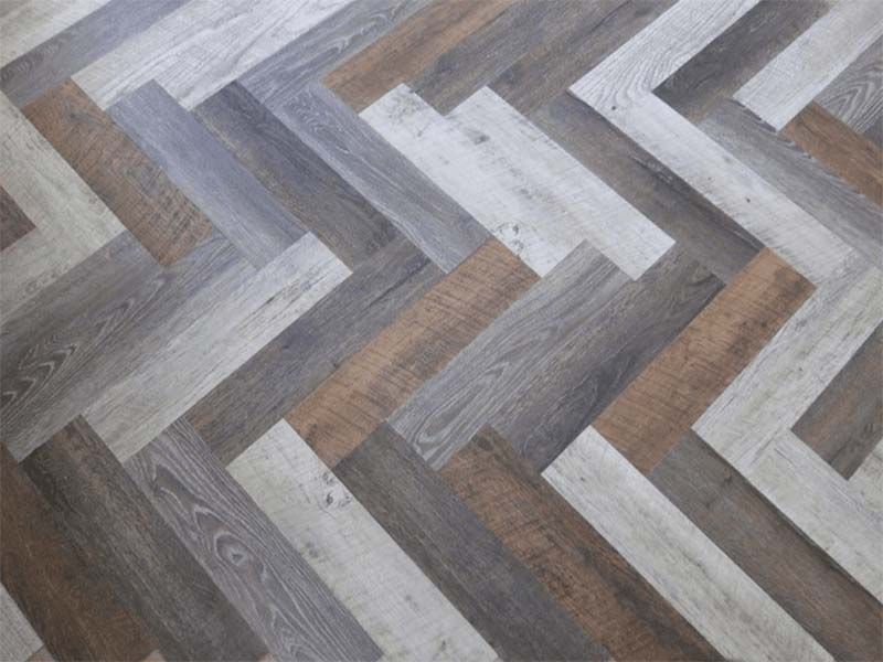 A Close Up of a Wooden Floor With a Herringbone Pattern — The Tile & Stone Specialists in Peregian Beach, QLD