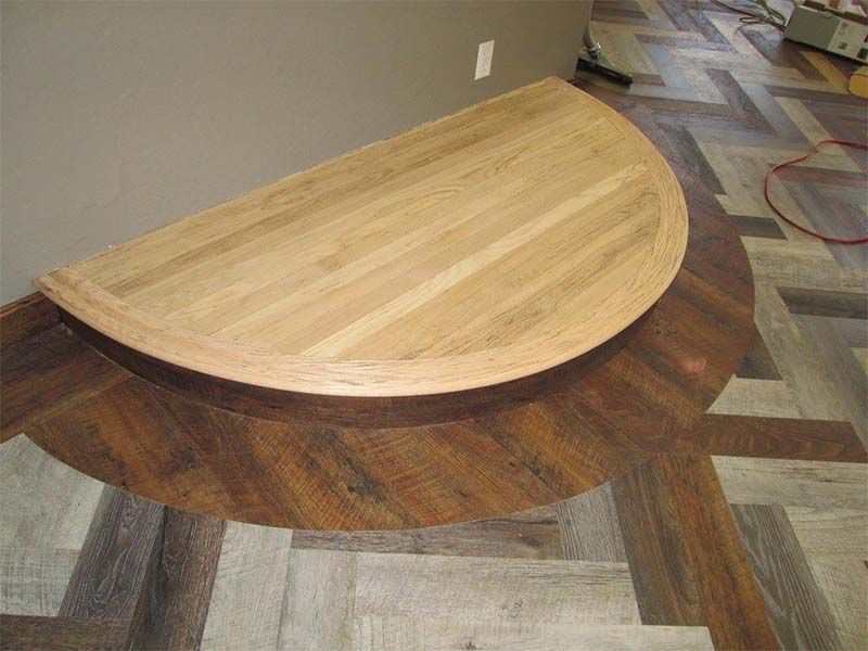 A Wooden Table is Sitting on Top of a Wooden Floor — The Tile & Stone Specialists in Peregian Beach, QLD