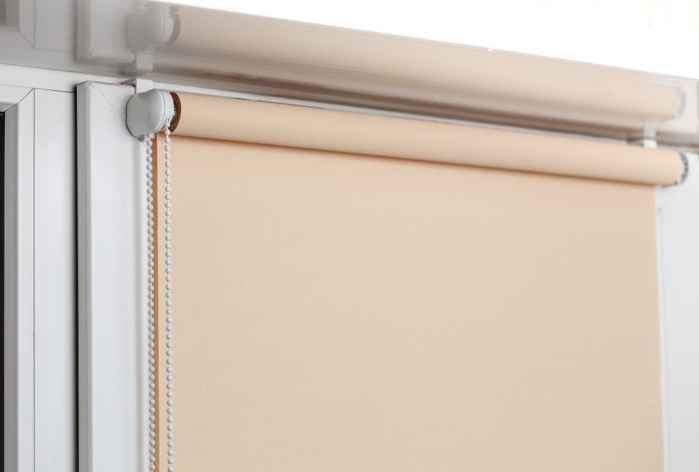 Beige Roller Blind Partially Covering a Window — GV Blinds in Wangaratta, VIC
