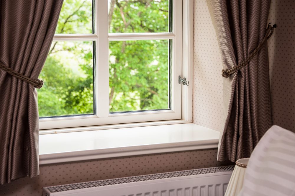 Window With Beige Curtains and Green Trees — GV Blinds in Wangaratta, VIC