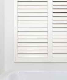 White Shuttered Window Above a White Bathtub in a Bathroom — GV Blinds in Shepparton, VIC