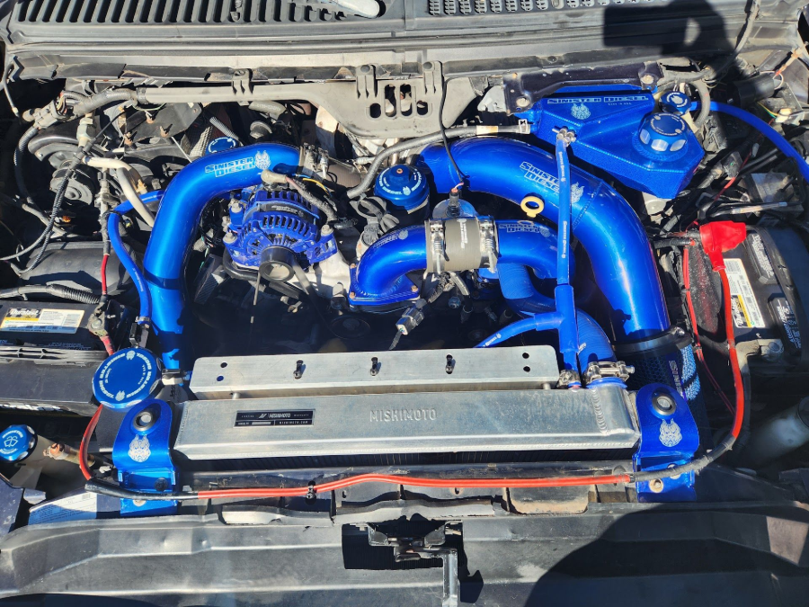 High-Performance Engine With Blue Intake System Under Repair | Brady’s Auto Repair