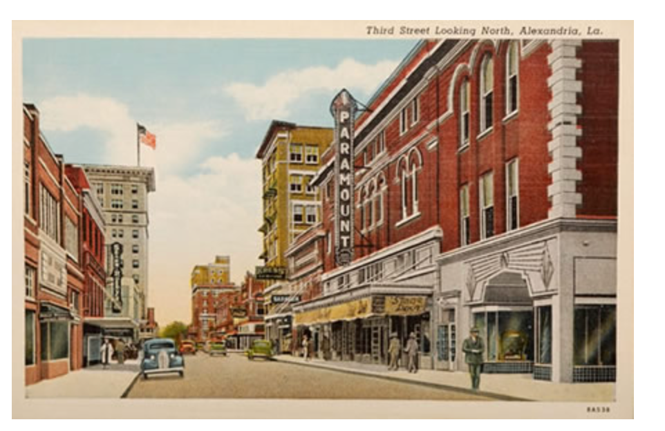 A postcard of a city street with a theater on the right