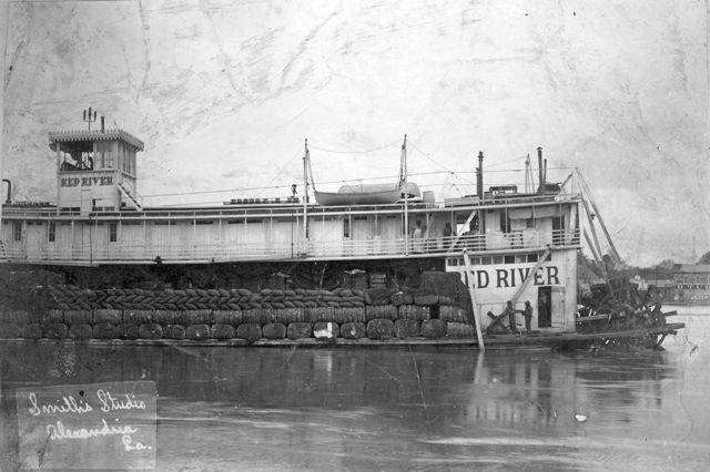 A black and white photo of a boat with the word river on it