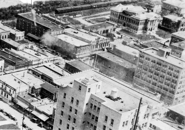 A black and white photo of a city with lots of buildings