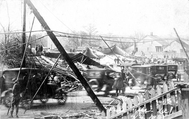 A black and white photo of cars parked on the side of the road.