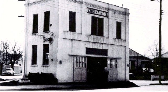 A black and white photo of a building that says chemist shop
