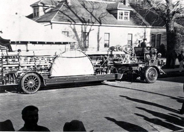 A black and white photo of a very old car
