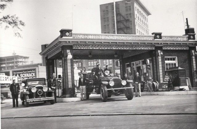 A black and white photo of an old gas station