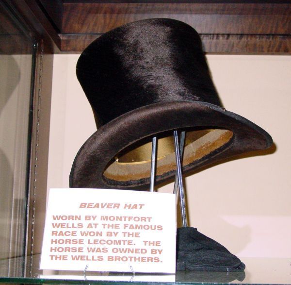 A beaver hat is on display in a glass case
