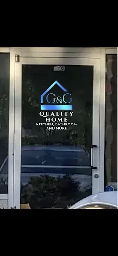 Glass door with “Quality Home Improvements” logo and lettering on a storefront.