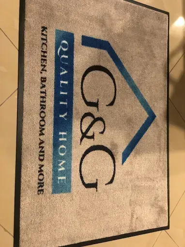 G&G Quality Home Kitchen, Bathroom and More sign with blue house roof logo on tan background