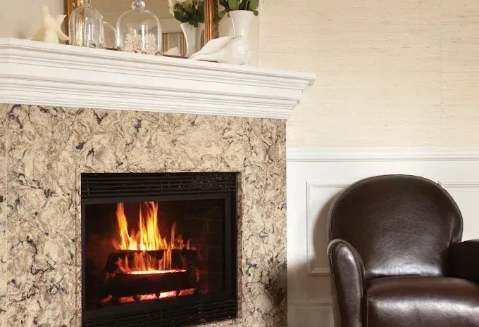 Cozy living room fireplace with burning fire beside a brown leather armchair