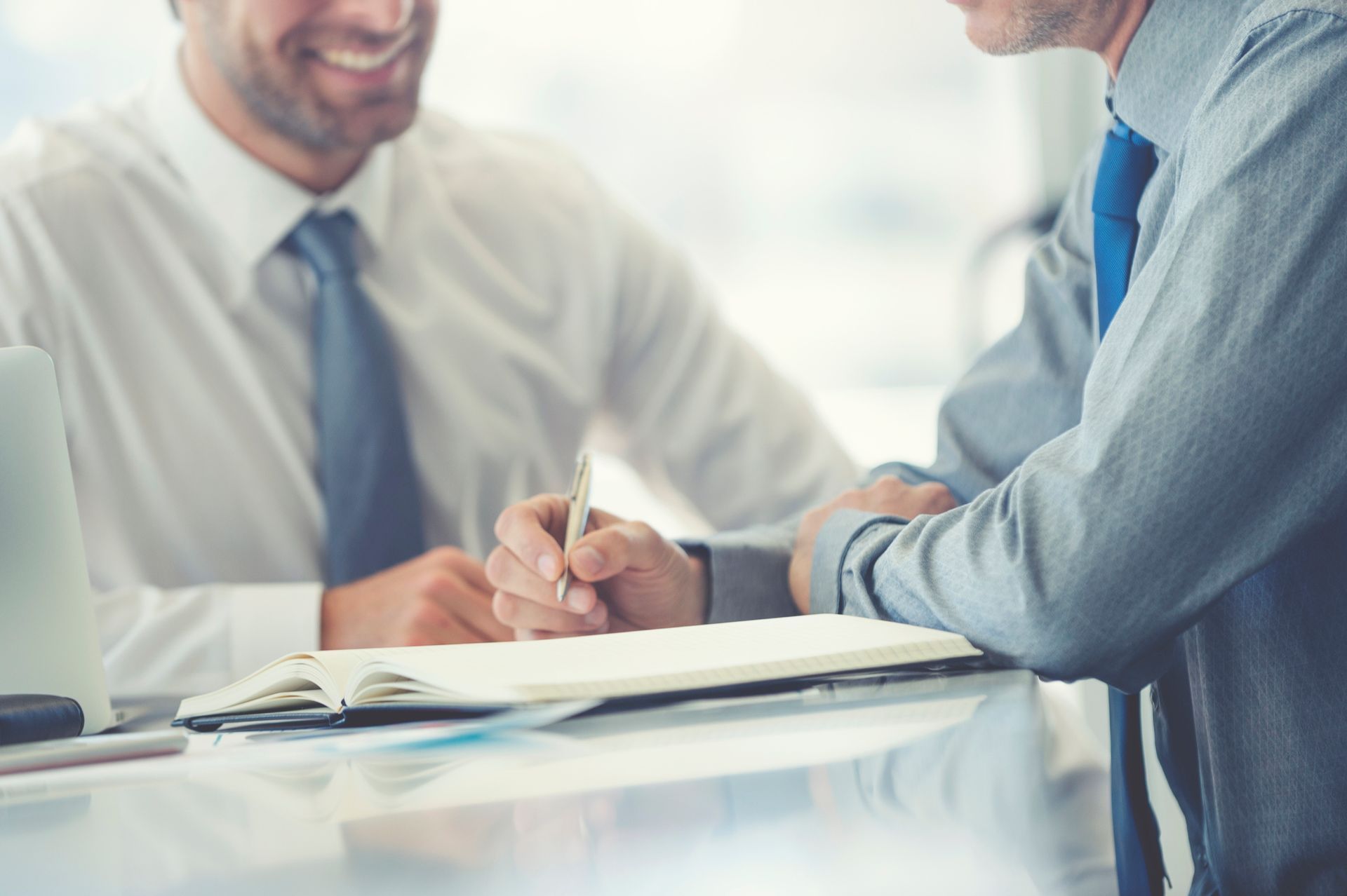 Two Men are Sitting at a Table — Perth, WA — Lenhoff & Hotz Two Men are Sitting at a Table — Perth, WA — Lenhoff & Hotz