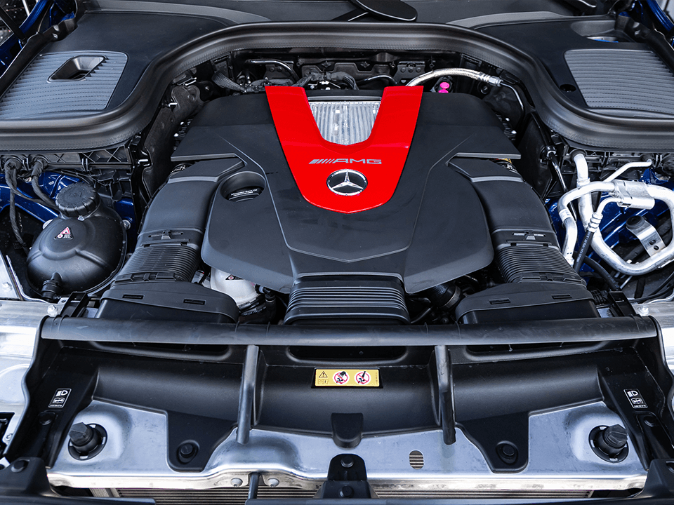 A close up of a car engine with a red v on it