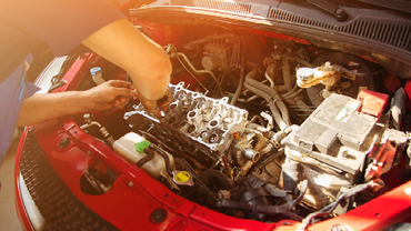 a mechanic working on a car engine.