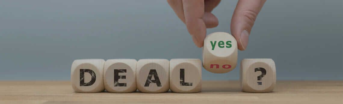 Hand holding a die that says