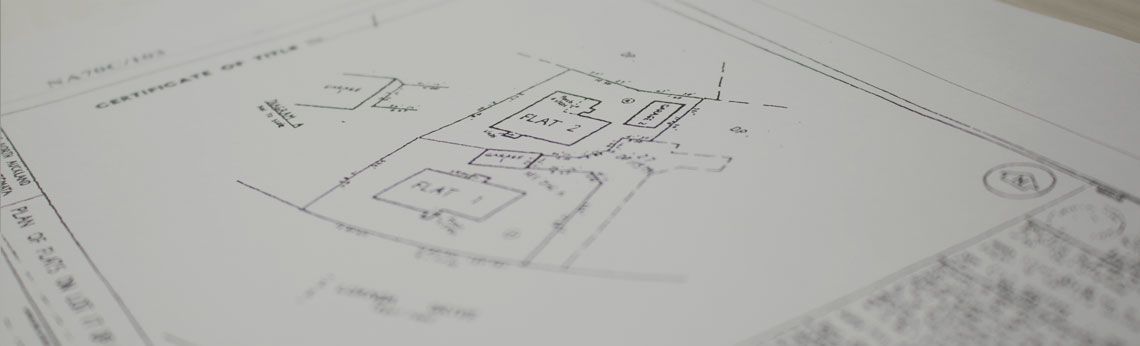 Architectural drawing of a building layout with handwritten annotations on a white sheet.