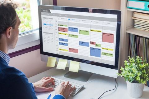 scheduling software on computer in office