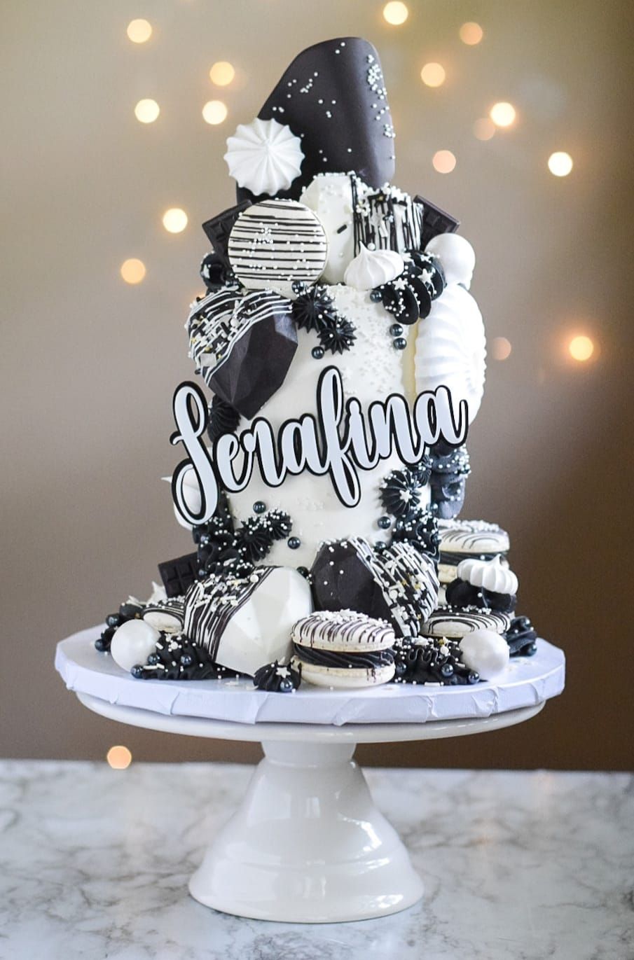 Cake decorated with black and white chocolate, meringue, and 