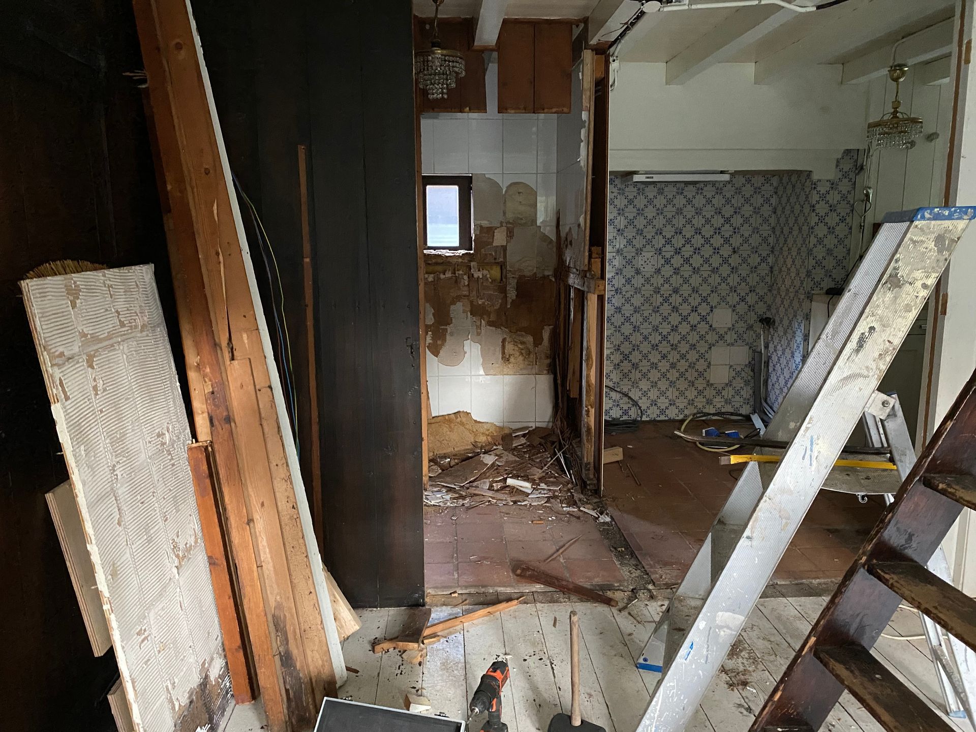 Hands installing white insulation board against an interior wall