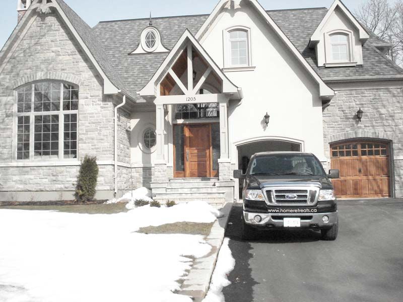 A ford truck is parked in front of a large house