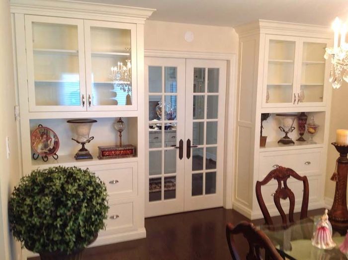 A living room with two flat screen tvs on the wall