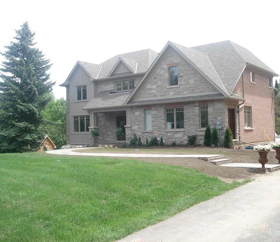 A large house with a lush green lawn in front of it