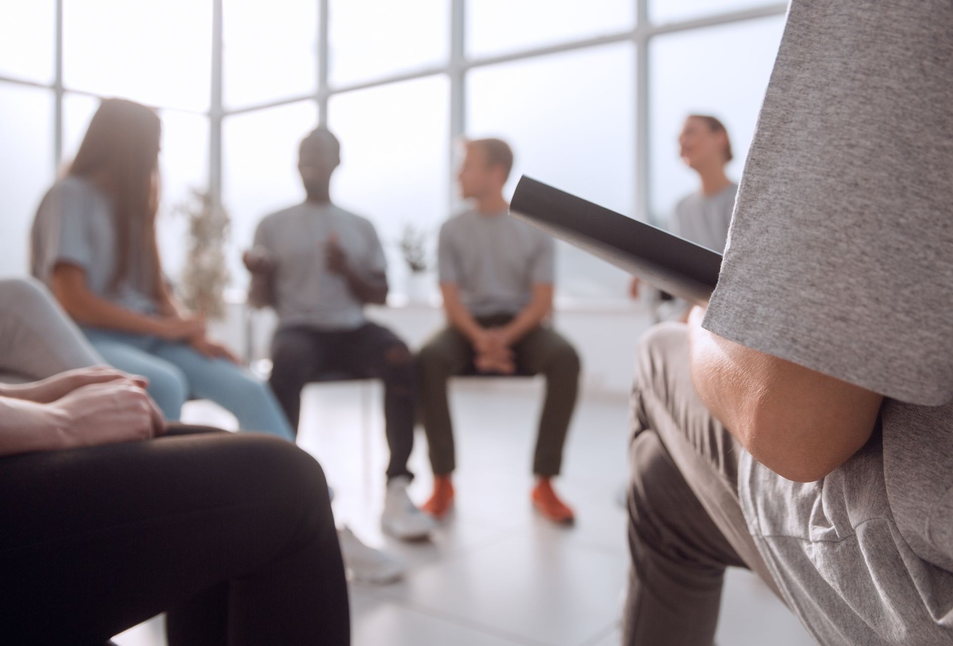 A group of people are sitting in a circle in a room.