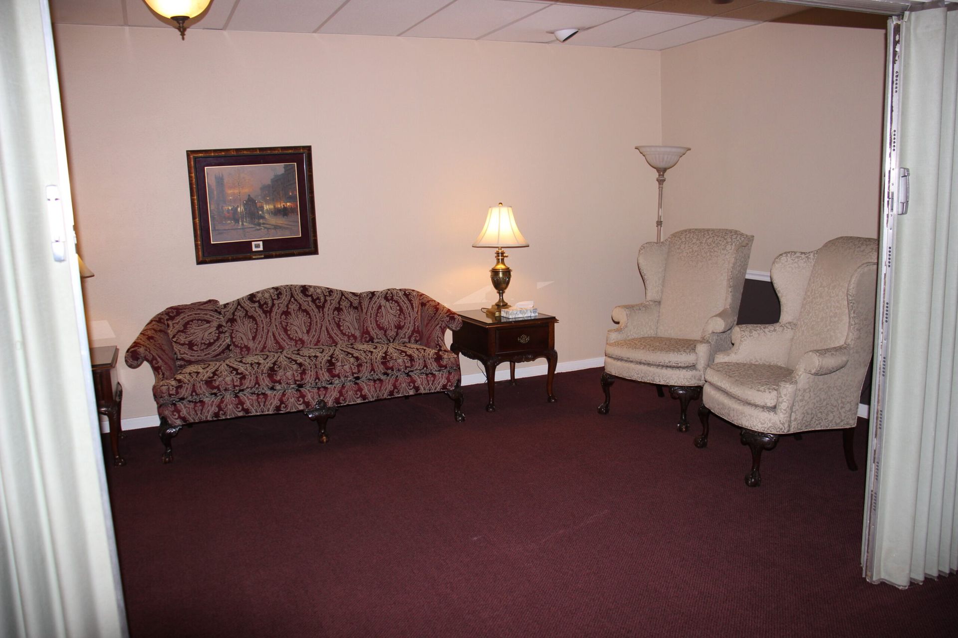 A living room with a couch and two chairs