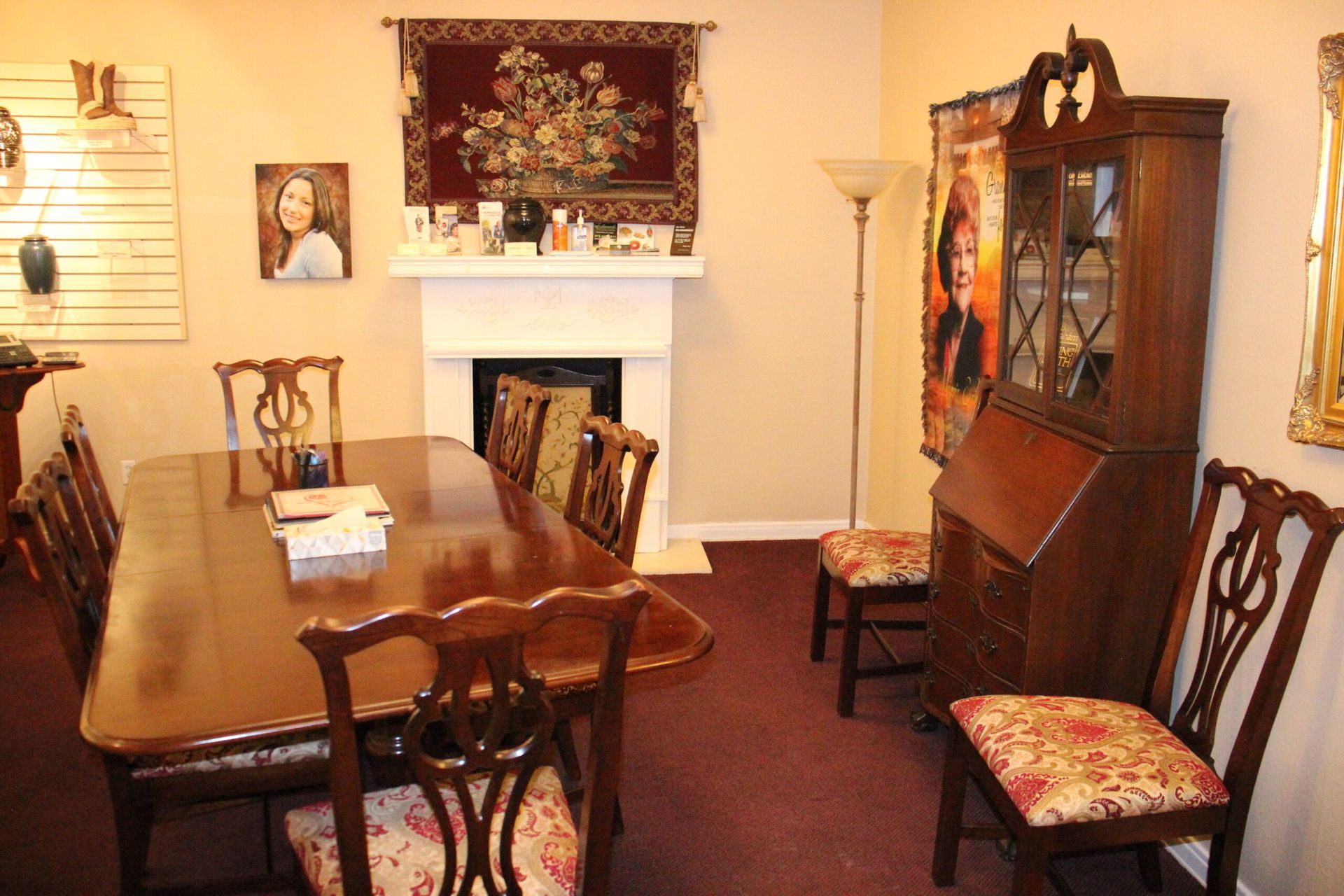 A dining room with a table and chairs and a fireplace
