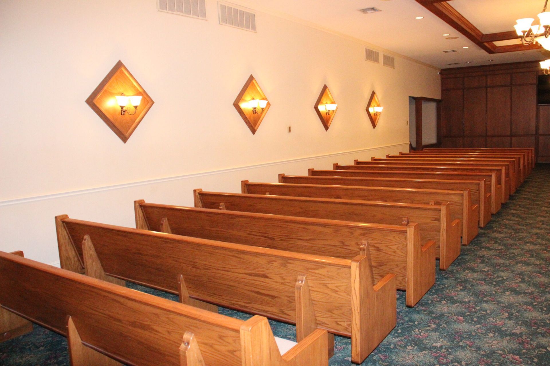 A row of wooden benches in an empty church