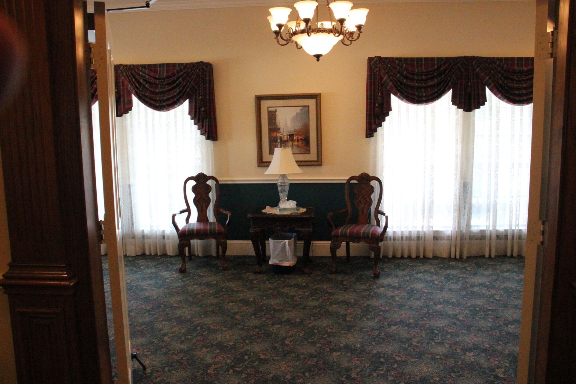 A room with a table and chairs and a chandelier
