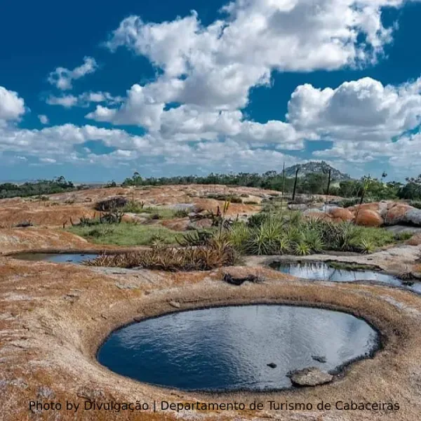 A rocky landscape with a small pond in the middle