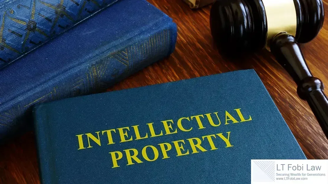 Books labeled “Intellectual Property” beside a gavel on a wooden desk
