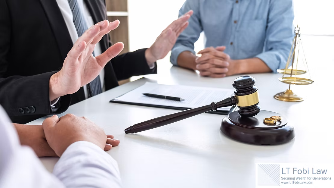 Lawyer gesturing in a meeting beside a judge’s gavel and scales on a conference table