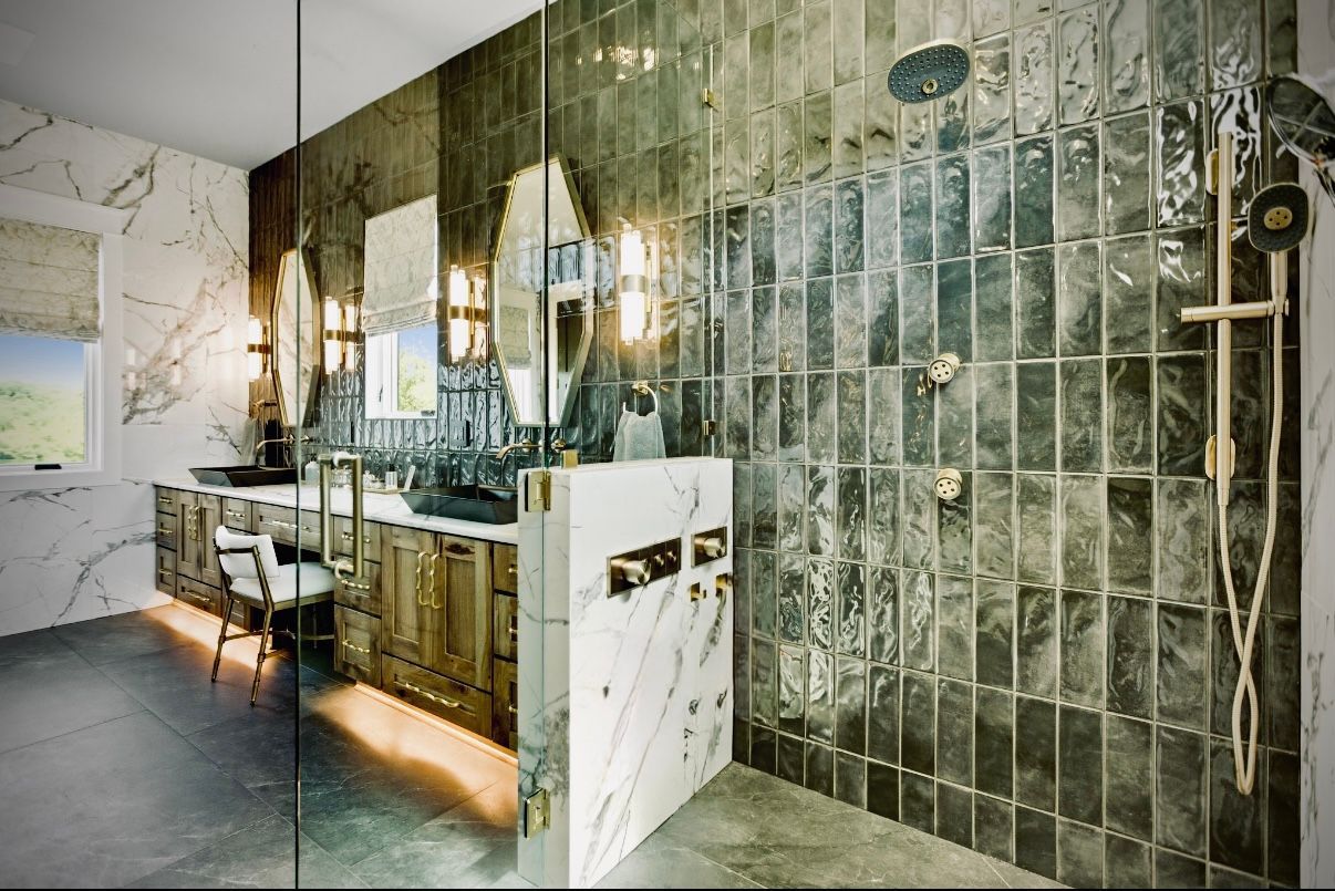Modern kitchen under renovation with stainless fridge, pendant lights, and a half-finished island countertop