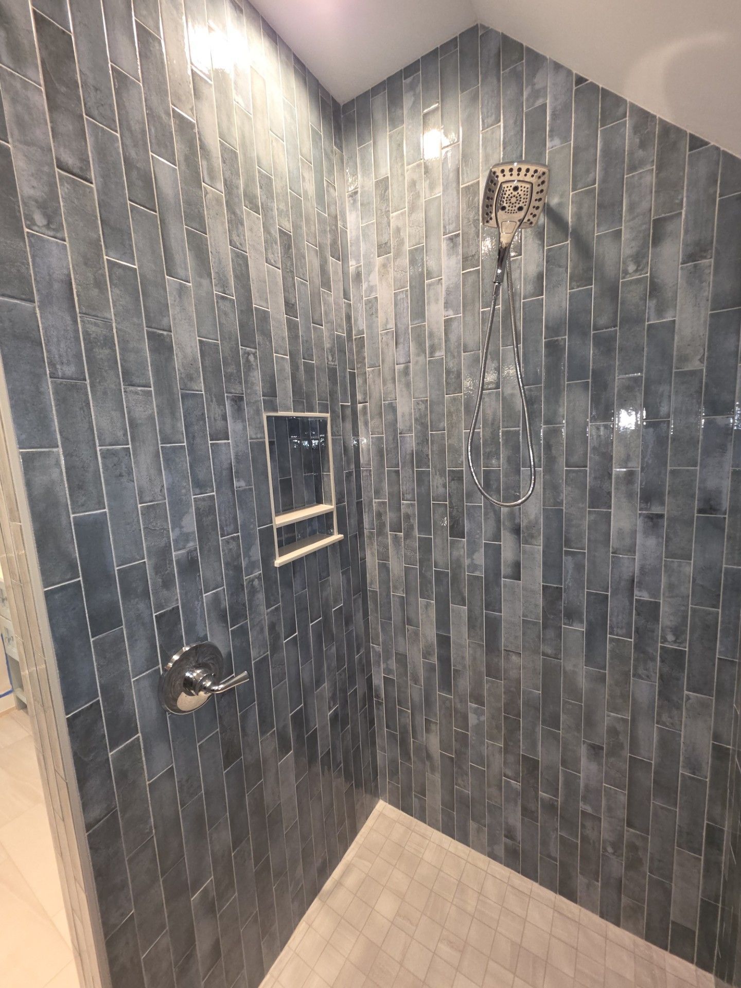 Modern bathroom with marble vanity, toilet, and large mirror in neutral tones