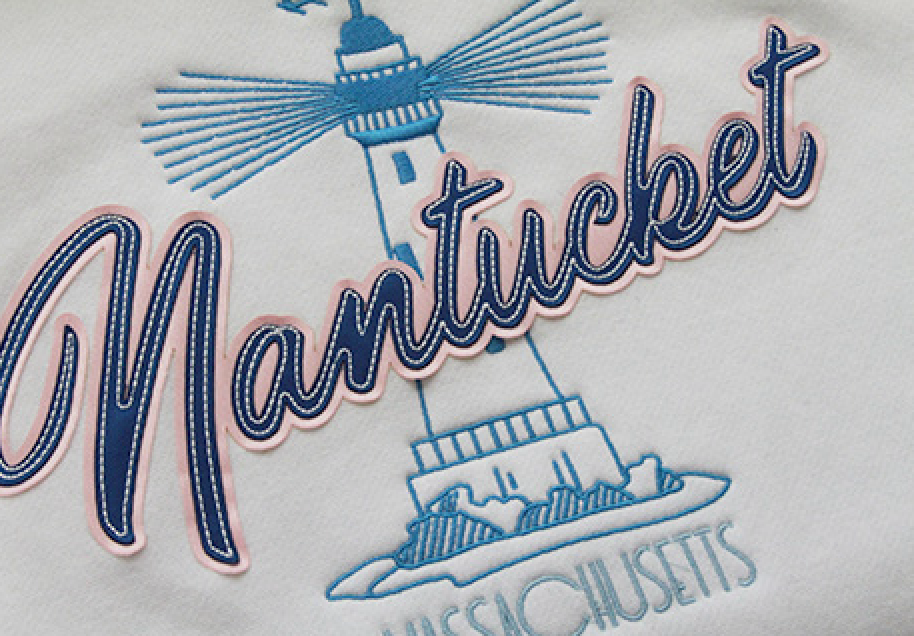 A white shirt with a lighthouse embroidered on it