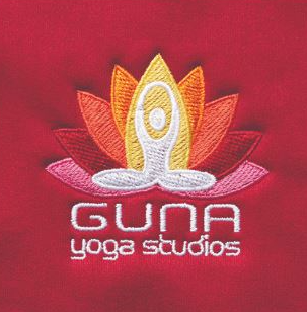 A red shirt with a logo for guna yoga studios