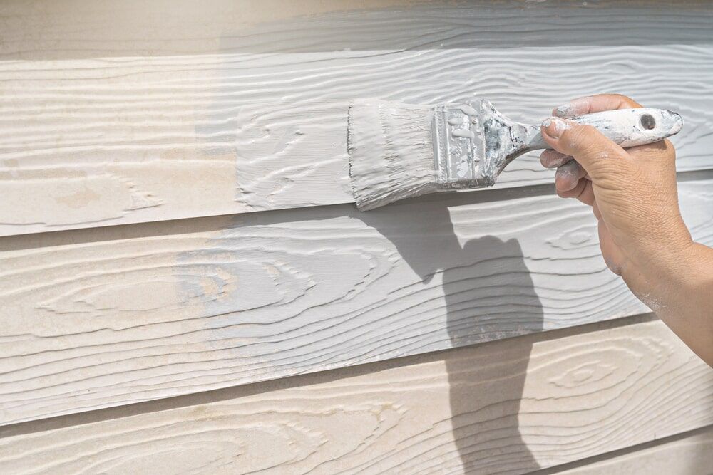 Someone Painting Grey Colour With Small Paint brush— Painting service in Yeppoon, QLD