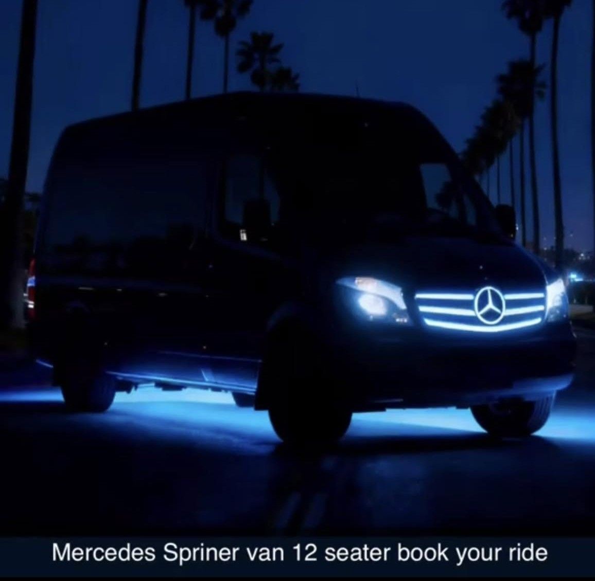 Black Mercedes Sprinter van with blue underglow parked at night